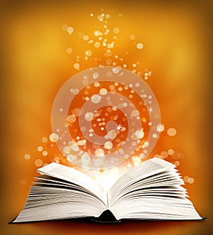 The open Magic Book with sparklings
