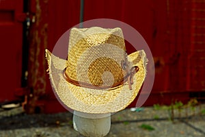 Open market stall with summer hats for men on sale.