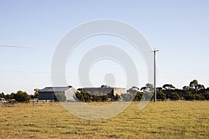 Open Meadow Leading Up To Farm Sheds