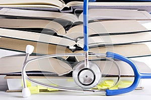 Open medical books, stethascope. Process of medical learning