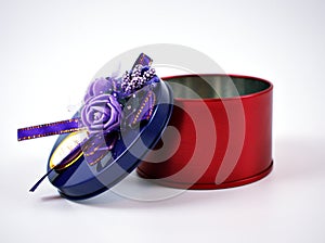 Open Metal round red gift box with violet ribbon on top isolated on white background ,purple on top