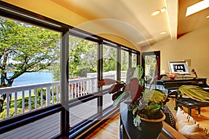 Open modern luxury home interior living room wth balcony window wall.