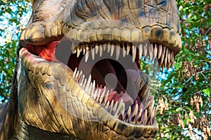 The open mouth of a tyrannosaur with huge sharp teeth