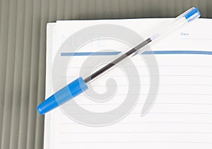 Open note book with lined pages free date space and ballpoint pe