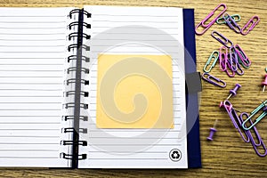 Open note book with stickies on wooden background. 3D illustration