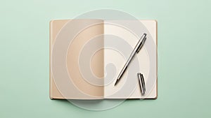 The notebook has a beige cover and the pages inside appear unruled