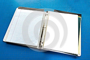 Open Notebook With Copy Space Against Blue Cutting Board Background