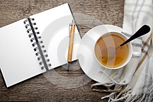 Open notebook and cup of tea