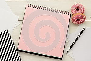 Open notebook and donuts