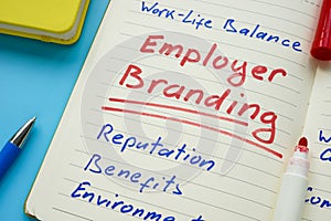 Open notebook and Employer branding inscription on the page. photo