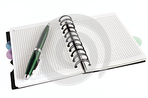 Open notebook with green pen