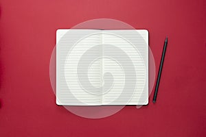 Open notebook isolated on red background, copy space for text