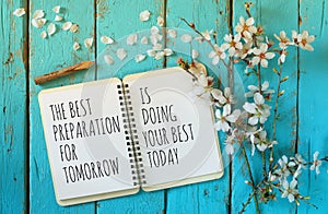 Open notebook over wooden table with motivational saying the best preparation for tomorrow is doing your best today