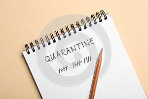 Open notebook and pencil on background, top view. Counting days of quarantine during coronavirus outbreak