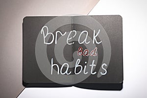 Open notebook with phrase Break Bad Habits on color background, top view