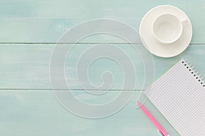 Open notebook with pink pen and coffeecup