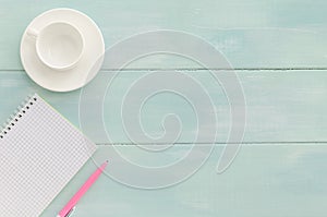 Open notebook with pink pen and coffeecup