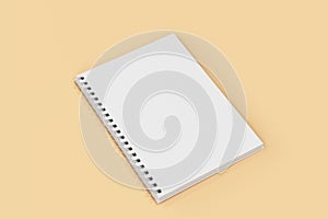 Open notebook spiral bound on orange background