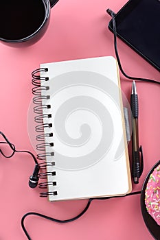 Open notebook on springs with white pages. Tablet, coffee and donuts. Mock up.