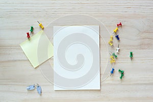 Open notebook and sticky note on wooden background.