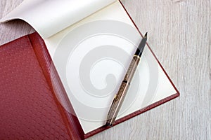 Open Notebook With White Pages And Gold Fountain Pen