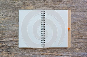 Open notebook on wooden background.