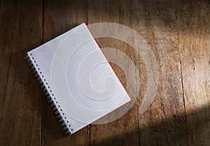 Open notebook on wooden background.