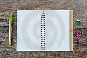 Open notebook on wooden background with wooden ruler.