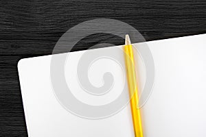 Open notebook and yellow pencil on wooden table,top view, Template mock up for adding your content