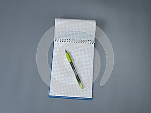 Open notepad in a cage with a mechanical pencil