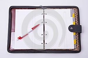 Open notepad case with pen on the white background