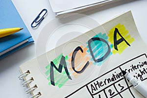 Open notepad with chart MCDA Multi-criteria decision analysis. photo
