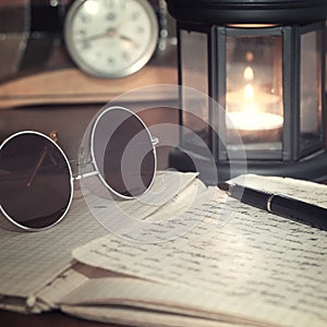 An open old book by the candlelight