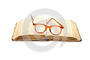 Open old book and glasses