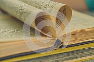 An open old book with sheets in the shape of a heart