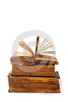 An open old book and vintage books on white background