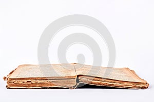 Open old book, white background.