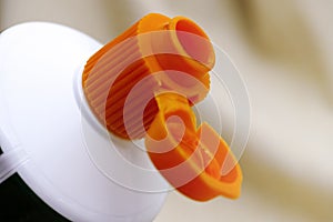 Open orange cap of toothpaste tube