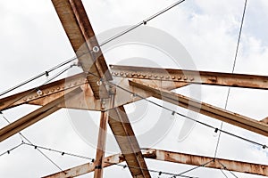 Open overhead girders and trusses covered in rust