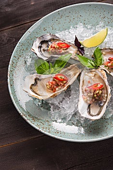 Open oyster stuffed with papper and lemon