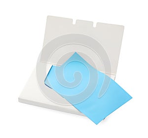 Open package of facial oil blotting tissues on white background