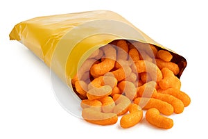 Open packet of extruded cheese puffs spilling out isolated on white
