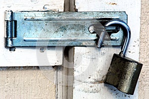 Open padlock on dirty shed door