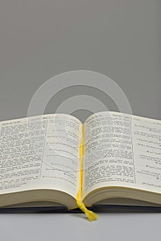 Open Page of the Noble Qur\'an Featuring Side-by-Side Arabic Script and English Translation with Yellow Bookmark photo