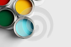 Open paint cans on white, top view. Space for text photo