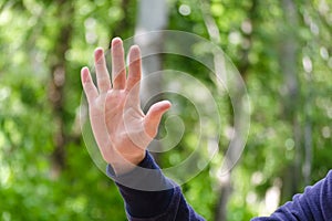 Open palm with spread fingers hand sign. Gesture mens hand of number or gives five. Concept of greeting, openness. Close Up view