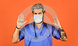 Open palm stop gesture. Epidemic threshold. Man in medical lab. Protective mask. Stop epidemic. Virus concept. Danger