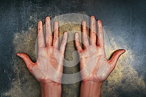 Open palms up of the girl`s hands in sequins on a dark background