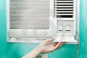 Open panel adjustment of a small room air conditioner.