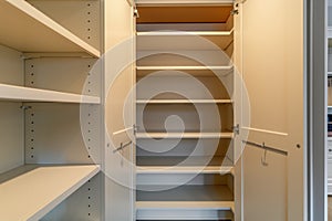 open pantry door revealing empty shelves